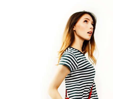 young pretty teenage hipster girl posing emotional happy smiling on white background, lifestyle people conceptの写真素材