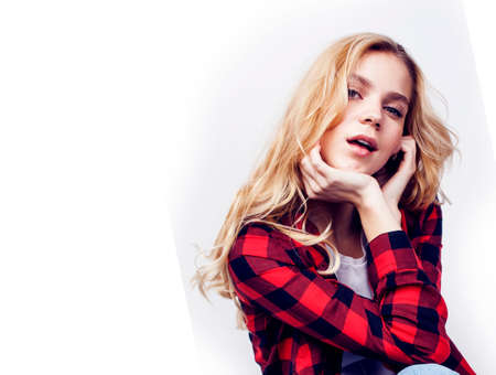 young pretty teenage hipster girl posing emotional happy smiling on white background, lifestyle people concept closeupの写真素材