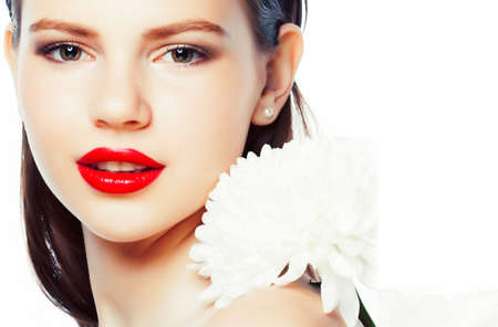 young brunette woman close up isolated on white background with flower, spa healthcare people conceptの写真素材