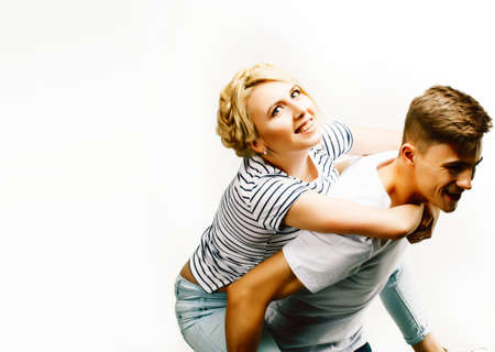 young pretty teenage couple, hipster guy with his girlfriend happy smiling and hugging isolated on white background, lifestyle people conceptの写真素材