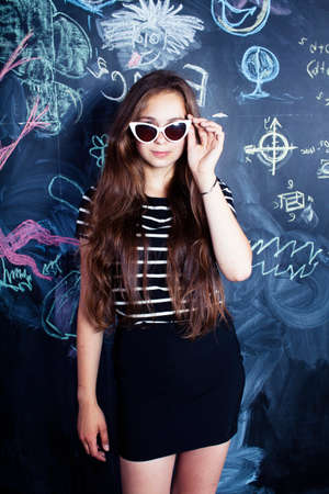 back to school after summer vacations, cute teen girl in classroomの写真素材
