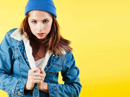lifestyle people concept: pretty young school teenage girl having fun happy smiling on yellow backgroundの写真素材