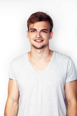 young handsome teenage hipster guy posing emotional, happy smiling against white background isolated, lifestyle people conceptの写真素材