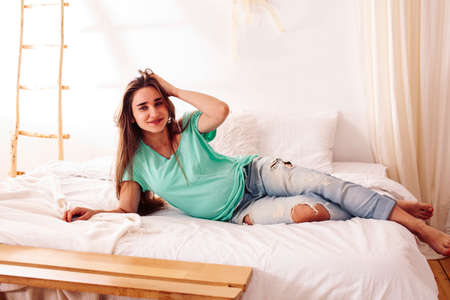 young pretty caucasian woman posing cheerful in bed, lifestyle people conceptの写真素材