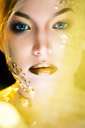 beauty blond woman with gold creative make up, luxury celebrationの写真素材