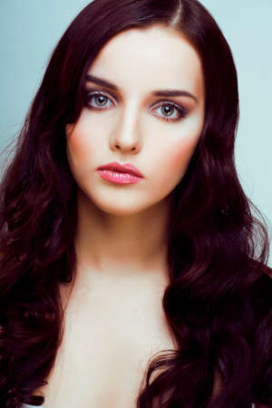 young pretty woman with hairstyle waves, luxury fashion make up look on white backgroundの写真素材