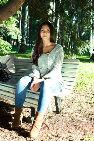 Young cute smiling real stylish dressed woman in green palm park smiling, resting, enjoing, lifestyle outside conceptの写真素材
