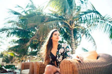 young pretty woman at swimming pool relaxing in chair, fashion look in lingerie at hotel, lifestyle people conceptの写真素材