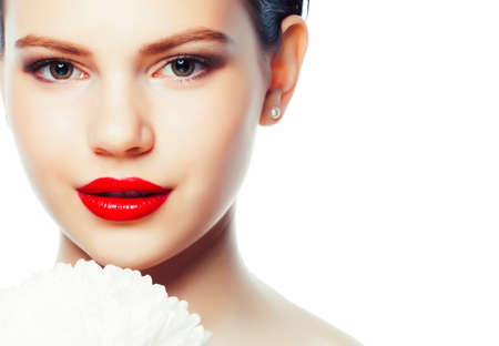 young brunette woman close up isolated on white background with flower, spa healthcare people conceptの写真素材