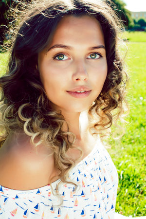 young cute summer girl on green grass outside relaxing smiling, lifestyle people conceptの写真素材