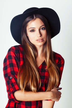 young pretty brunette girl hipster in hat on white background casual close up dreaming smilingの写真素材