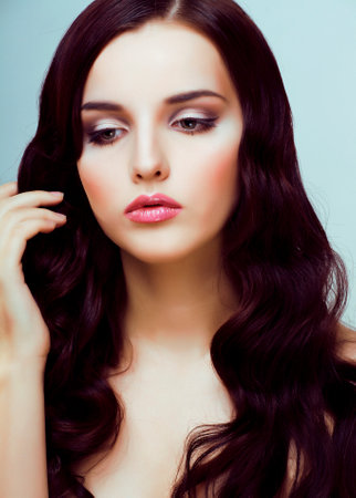 young pretty woman with hairstyle waves, luxury fashion make up look on white backgroundの写真素材