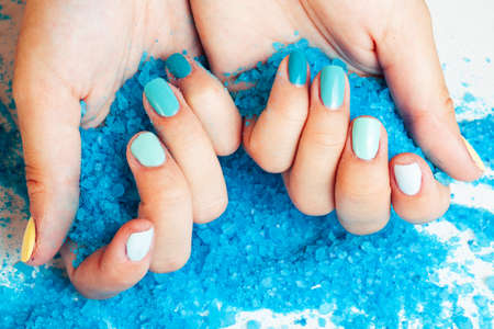 manicure with blue nails and seasalt close up like heart, love for summerの写真素材