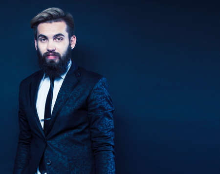 young attractive bearded hipster man gesturing emotional screaming in studio sucsess. fashion modern brutal guyの写真素材