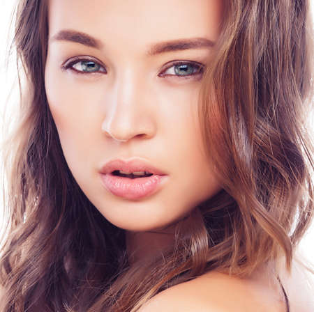 young sweet brunette woman close up isolated on white background, perfect pure innocense beautifulの写真素材