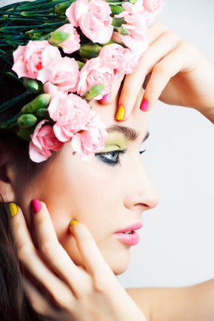 Beauty young real woman with pink flowers and make up closeup, spa salon, womans day conceptの写真素材