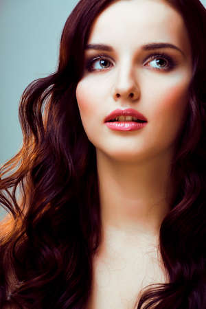 young pretty woman with hairstyle waves, luxury fashion make up look on white backgroundの写真素材