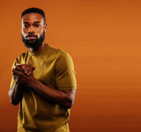 young pretty african american man posing cheerful on brown background, lifestyle people concept