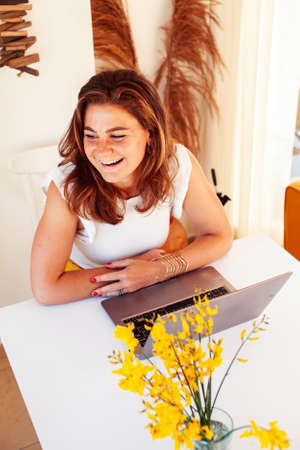 young pretty redhair woman posing cheerful with laptop in her room, lifestyle people conceptの写真素材