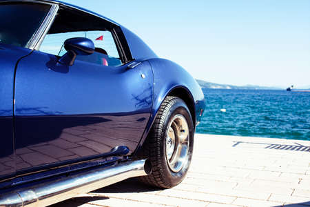 real old fashion cabriolet car at seaside touristic view lifestyleの写真素材