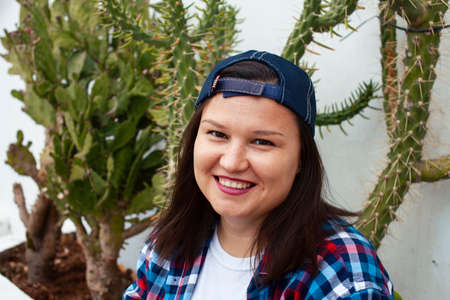yound pretty american woman siting smiling among cactuses, lifestyle people conceptの写真素材