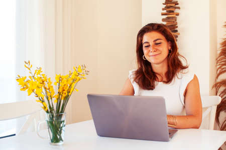 young pretty redhair woman posing cheerful with laptop in her room, lifestyle people conceptの写真素材