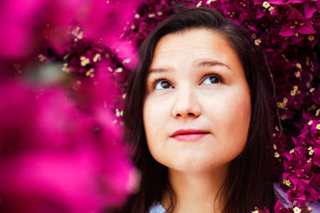 young pretty brunette girl surrounded by purple flowers, lifstyle people touristic seasonの写真素材