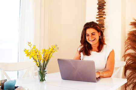 young pretty redhair woman posing cheerful with laptop in her room, lifestyle people conceptの写真素材