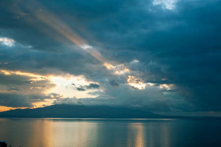 beautiful landscape on sea with sunset, dramatic clouds with red fire