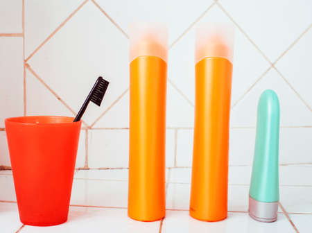 usual stuff in bathroom, shampoo, accessories, black stylish toothbrush, casual normal real background close upの写真素材