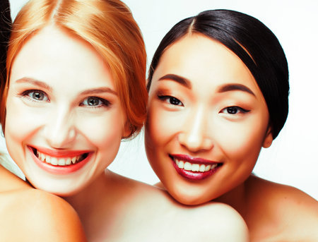 different nation woman: caucasian and asian together isolated on white background happy smiling, diverse type on skin, lifestyle people conceptの写真素材