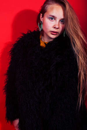 young pyoung pretty emitonal posing teenage girl on bright red background, happy smiling lifestyle people conceptの写真素材