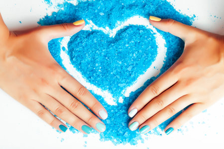 manicure with blue nails and seasalt close up like heart, love for summerの写真素材