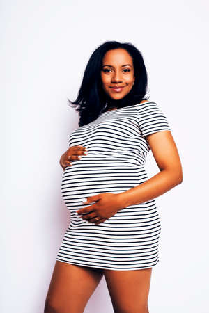 young pretty african american woman pregnant happy smiling, posing on white background isolated , lifestyle people concept copyspace close upの写真素材