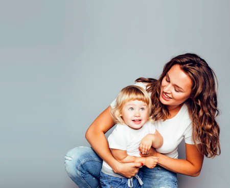 bright picture of hugging mother and daughter happy together, smiling stylish family. girls aloudの写真素材