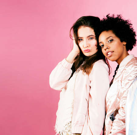 different nation girls with diversuty in skin, hair. Asian, scandinavian, african american cheerful emotional posing on pink background, woman day celebration, lifestyle people concept close upの写真素材