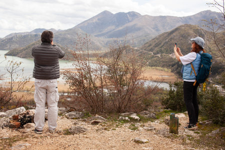 senior friends tourists outdoor adventure together on mediterranian seaの写真素材