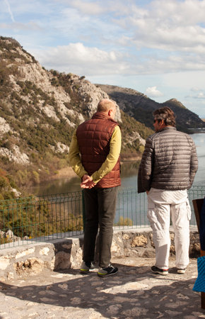 senior friends tourists outdoor adventure together on mediterranian seaの写真素材