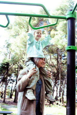 mother with little daughter on playground outside