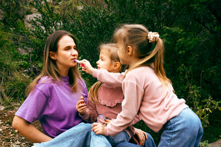 mother with daughter outside having funの写真素材