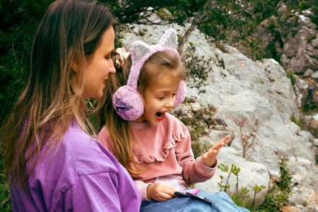 mother with daughter outside having funの写真素材