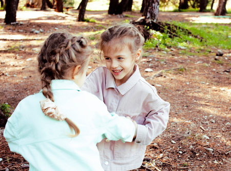 two pretty sisters twins playing outside, lifestyle people conceptの写真素材
