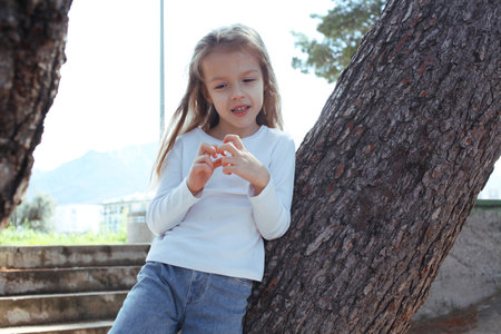 young pretty girl dreaming on tree, lifestyle people conceptの写真素材