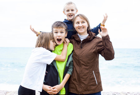 mother with children shooting on phone outside, happy memory, lifestyle people conceptの写真素材