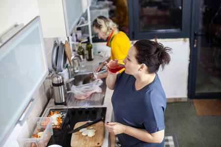 two mature woman same sex couple cooking dinner together, lifestyle people conceptの写真素材