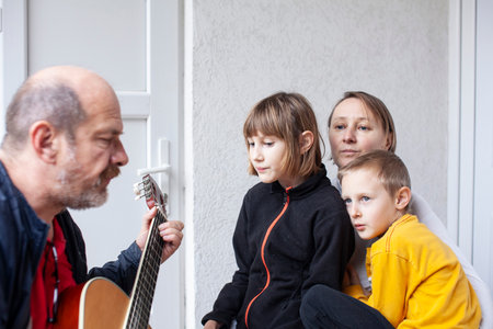 father of real family playing guitar singing, lifestyle people concept