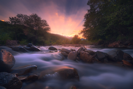 sunrise over fast mountain riverの写真素材
