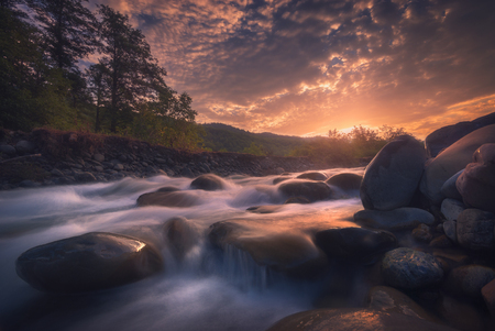 sunrise over fast mountain riverの写真素材