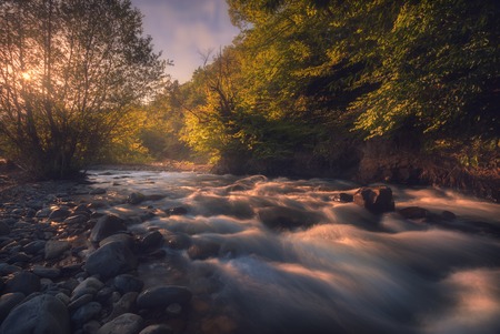 sunrise over fast mountain riverの写真素材