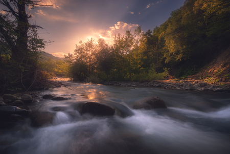 sunrise over fast mountain riverの写真素材